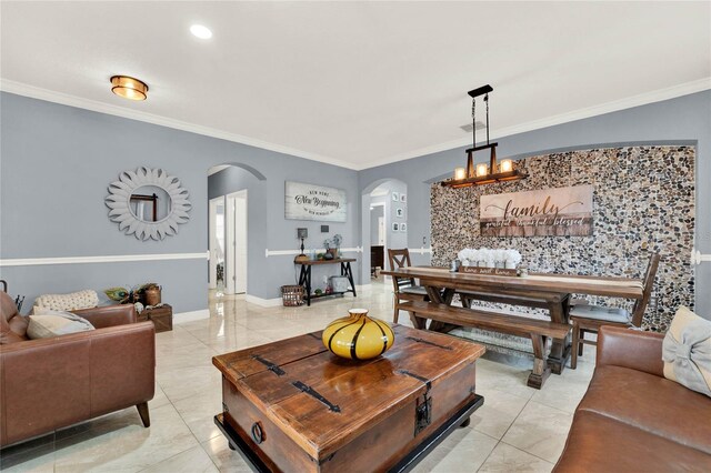 living room featuring light tile patterned flooring, crown molding, and a chandelier