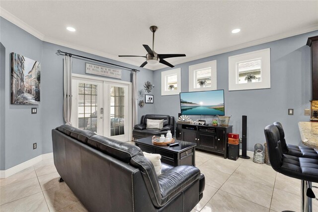 tiled living room with french doors, crown molding, and ceiling fan