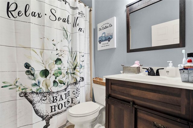 bathroom featuring vanity and toilet