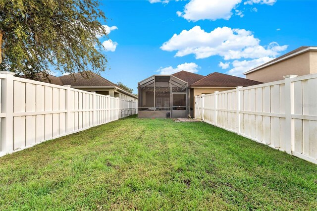 view of yard featuring glass enclosure