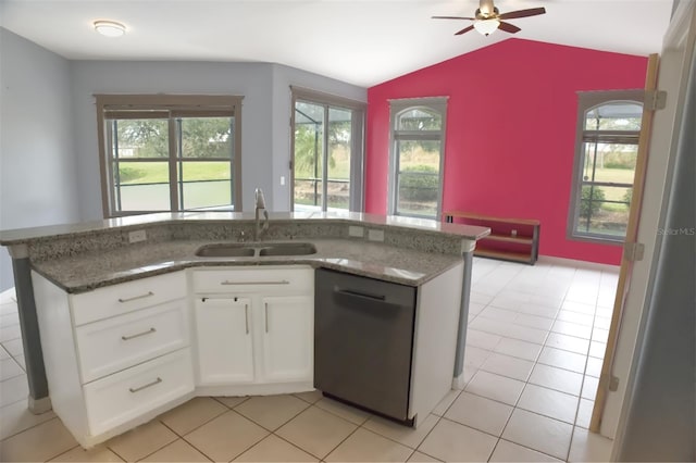 kitchen with black dishwasher, dark stone countertops, sink, vaulted ceiling, and white cabinets