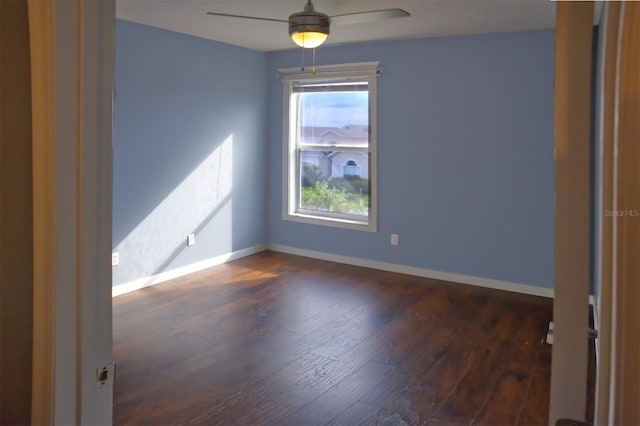 unfurnished room with ceiling fan and dark hardwood / wood-style floors