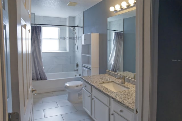 full bathroom featuring a textured ceiling, toilet, vanity, shower / tub combo with curtain, and tile patterned flooring