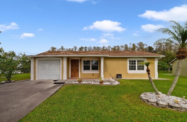 ranch-style house featuring a front yard and a garage