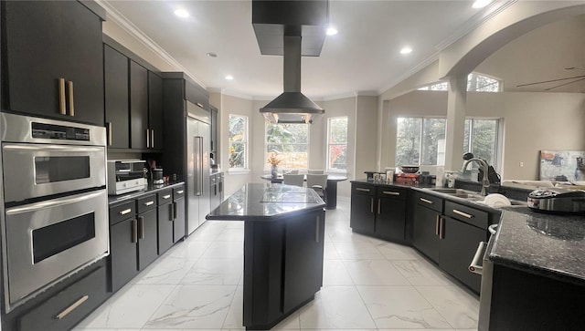 kitchen with sink, a center island, dark stone counters, decorative light fixtures, and appliances with stainless steel finishes