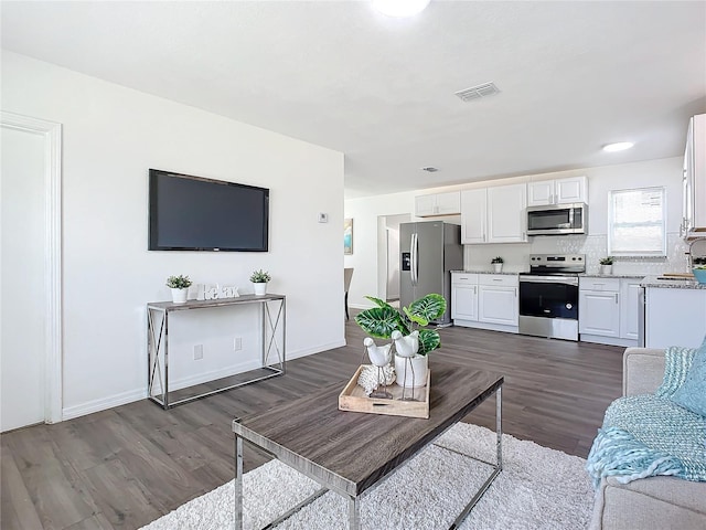 living room with dark hardwood / wood-style floors and sink