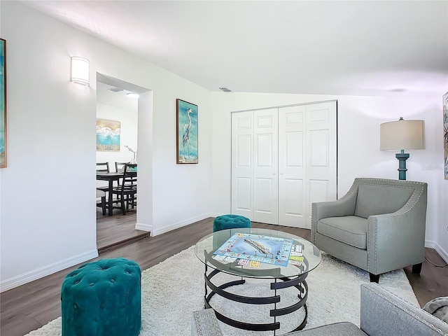 living room featuring lofted ceiling and hardwood / wood-style floors