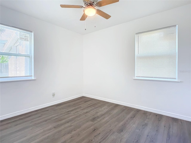 empty room featuring ceiling fan and dark wood-type flooring