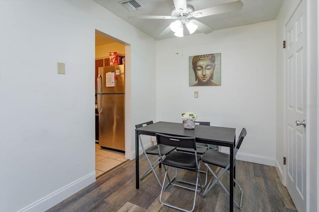 dining area featuring wood-type flooring and ceiling fan