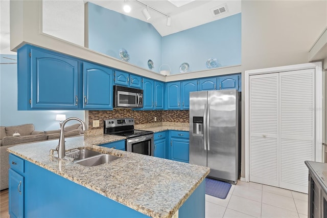 kitchen featuring sink, kitchen peninsula, blue cabinets, stainless steel appliances, and high vaulted ceiling