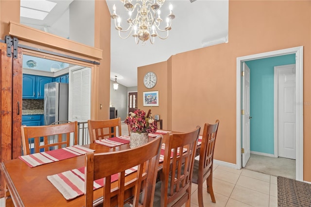 dining room with an inviting chandelier, a skylight, high vaulted ceiling, and light tile patterned floors