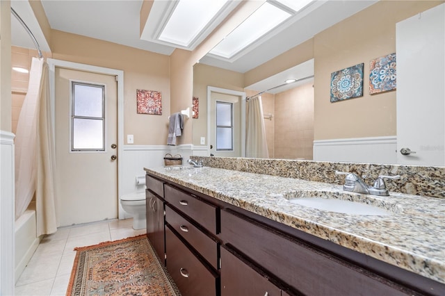 bathroom featuring vanity, toilet, and tile patterned flooring