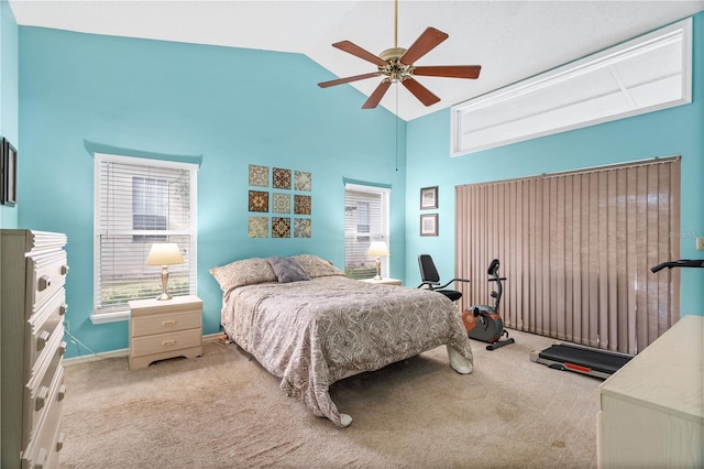 bedroom featuring multiple windows, light colored carpet, and ceiling fan