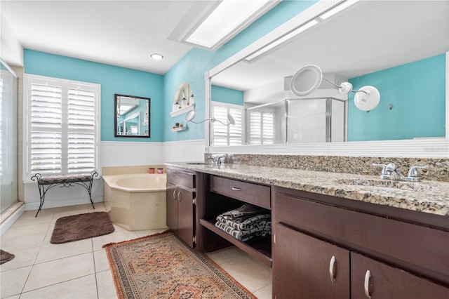 bathroom with vanity, plus walk in shower, and a healthy amount of sunlight