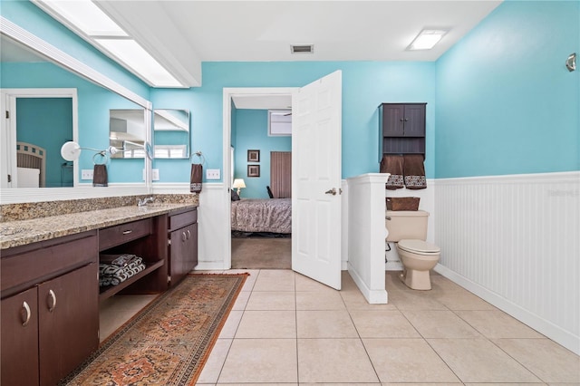 bathroom with vanity, toilet, and tile patterned flooring