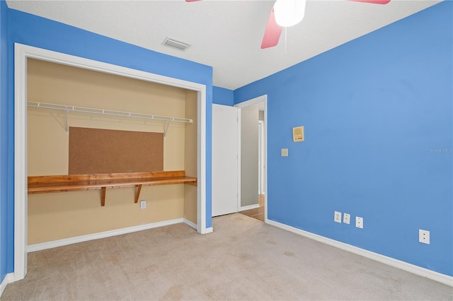 unfurnished bedroom with a closet, ceiling fan, and light carpet