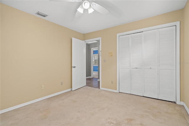 unfurnished bedroom featuring a closet, ceiling fan, and light carpet