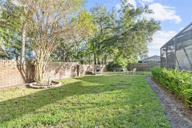 view of yard featuring a lanai