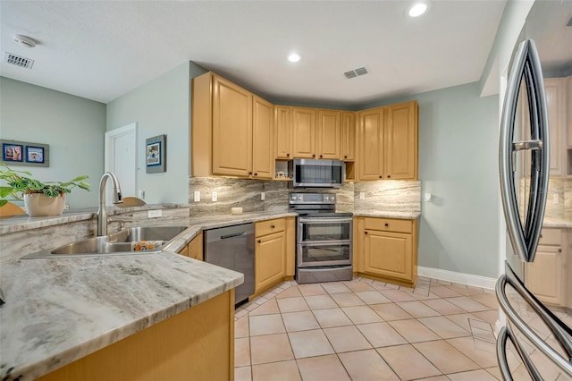 kitchen featuring light tile patterned floors, stainless steel appliances, light brown cabinetry, and sink