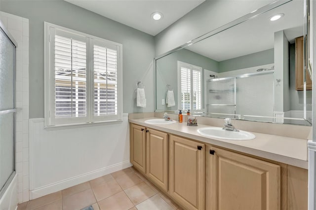 bathroom featuring a wealth of natural light, vanity, combined bath / shower with glass door, and tile patterned floors