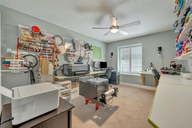 carpeted office featuring a textured ceiling and ceiling fan