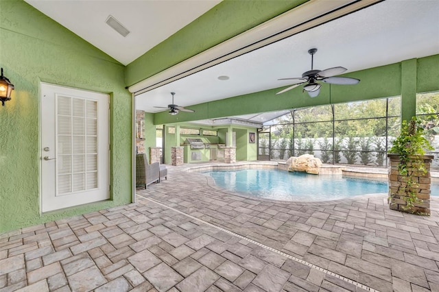 view of swimming pool with a patio, a lanai, and ceiling fan