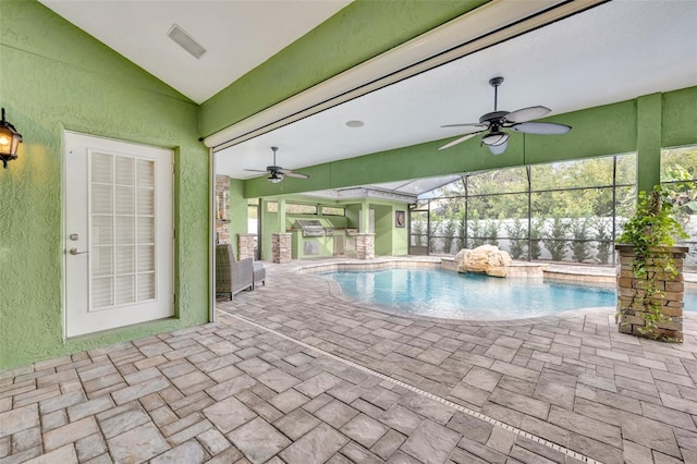 outdoor pool with a patio, ceiling fan, and exterior kitchen