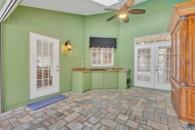 exterior space featuring french doors, ceiling fan, and sink