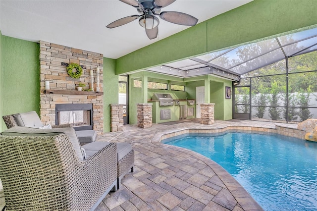 view of swimming pool with ceiling fan, area for grilling, a lanai, a patio area, and a grill