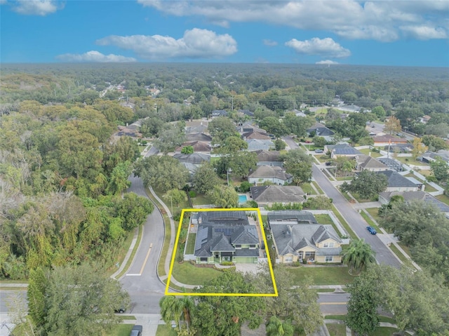aerial view featuring a residential view and a wooded view