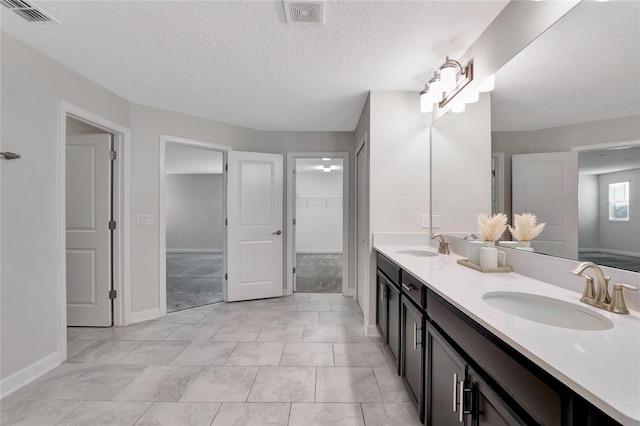 bathroom with vanity and a textured ceiling