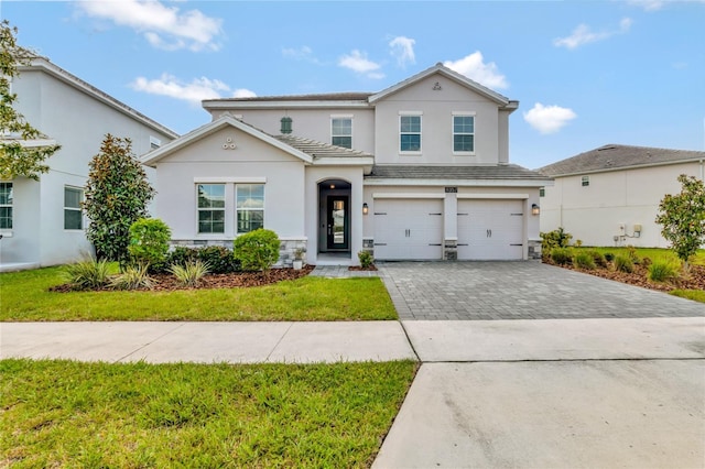 view of front property featuring a garage and a front lawn