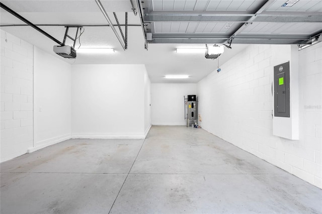 garage featuring a garage door opener, concrete block wall, electric panel, and hybrid water heater