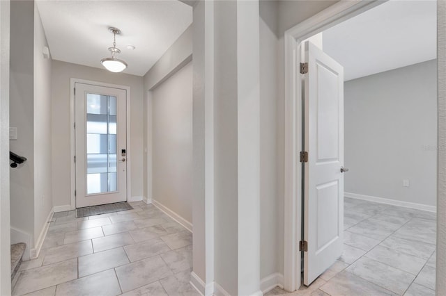 entryway featuring baseboards