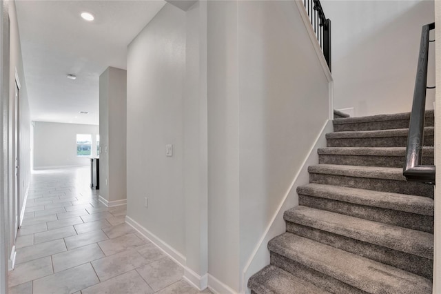 staircase featuring recessed lighting, baseboards, and tile patterned floors