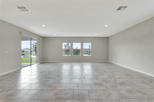 spare room featuring light tile patterned flooring, baseboards, visible vents, and recessed lighting