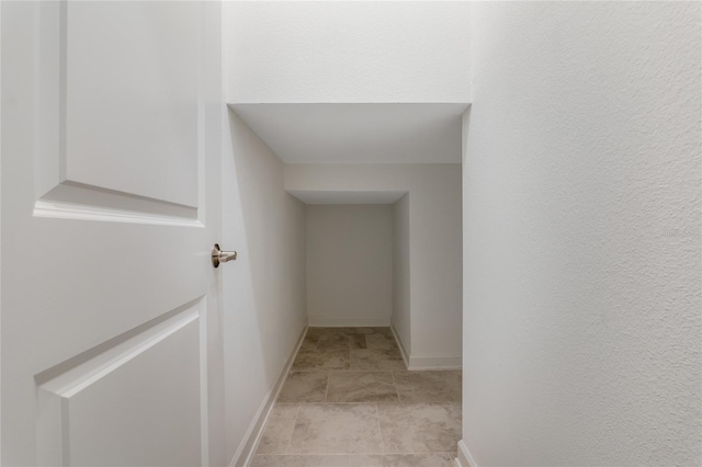 corridor featuring baseboards