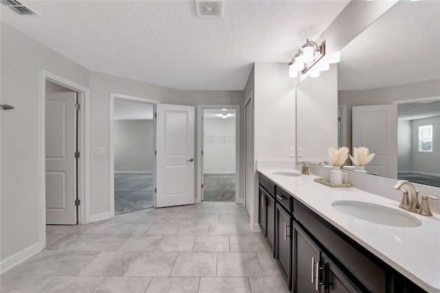 full bathroom featuring double vanity, a sink, and visible vents