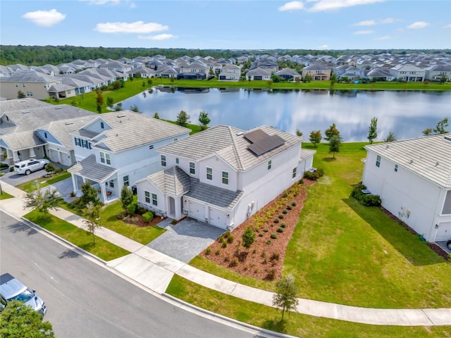 drone / aerial view featuring a residential view and a water view