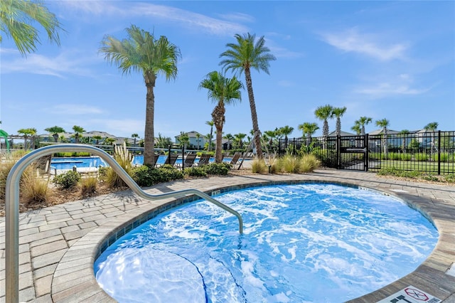 view of pool featuring fence and a swimming pool