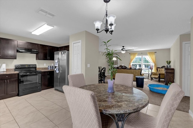 tiled dining room with ceiling fan with notable chandelier