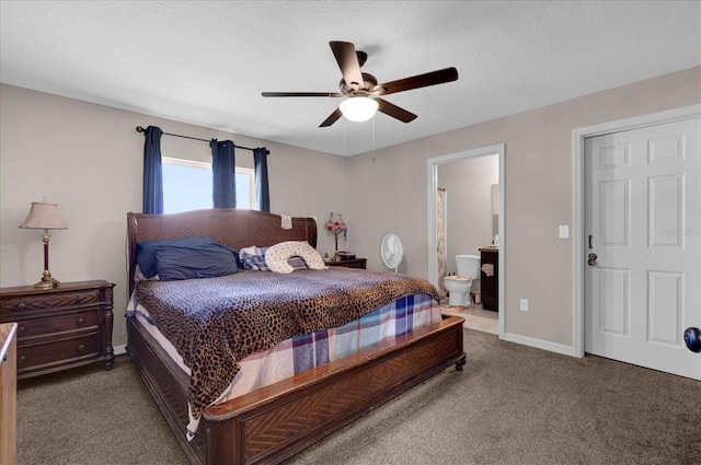 carpeted bedroom with ensuite bath and ceiling fan