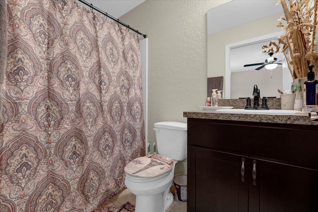 bathroom with vanity, a shower with shower curtain, toilet, and ceiling fan