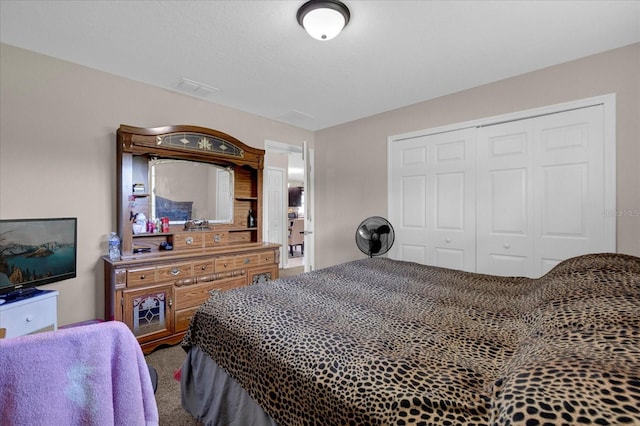 carpeted bedroom featuring a closet