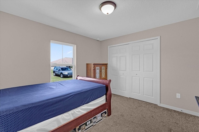 carpeted bedroom with a closet