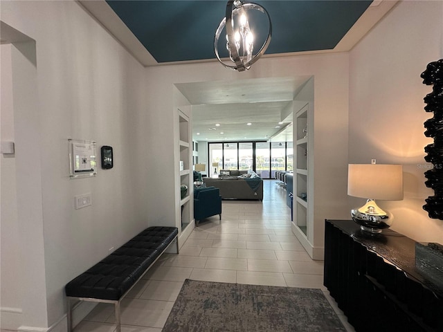 corridor featuring expansive windows, an inviting chandelier, and tile patterned flooring