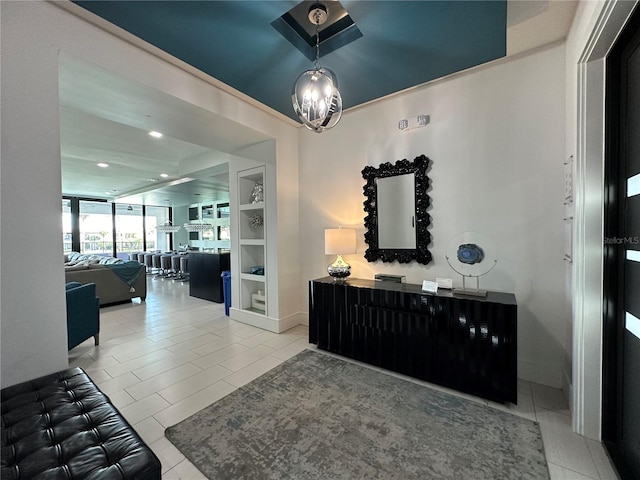 hall featuring built in shelves and light tile patterned flooring