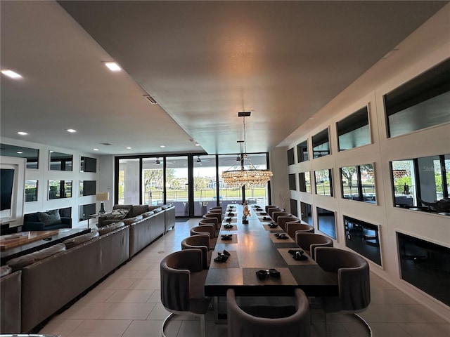 dining space featuring expansive windows and a notable chandelier