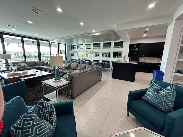 living room featuring sink and floor to ceiling windows