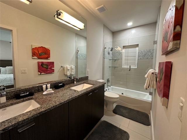 full bathroom with vanity, bath / shower combo with glass door, tile patterned floors, and toilet